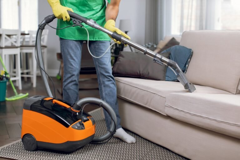 Erikos Cleaning janitor vacuuming upholstered office seating